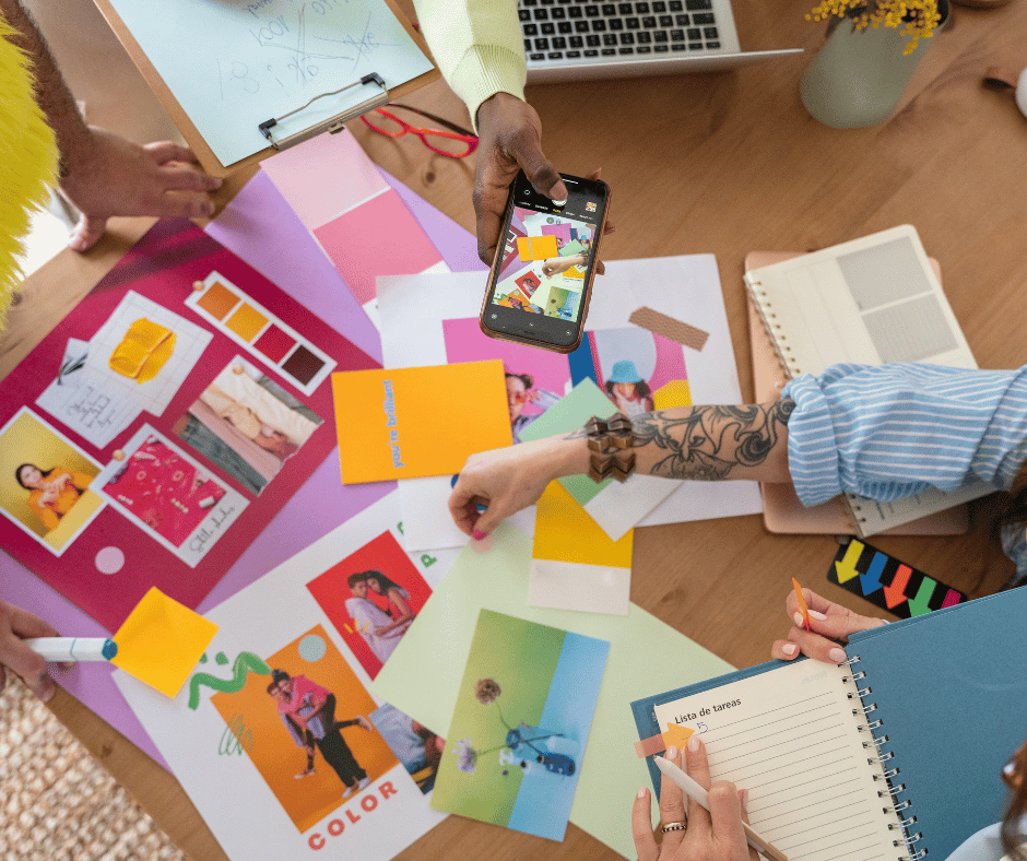 Creative team reviewing colorful design moodboard at a desk